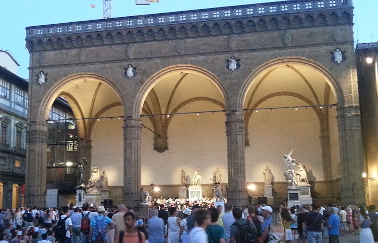 Loggia Lanzi at twilight in Piazza Signoria with live music.