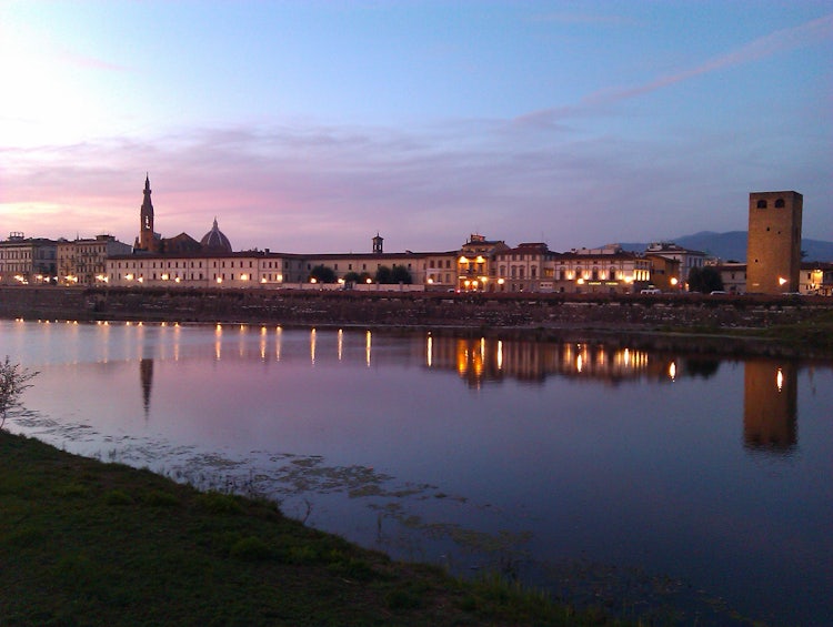 The Arno River at night with the Florence skyline