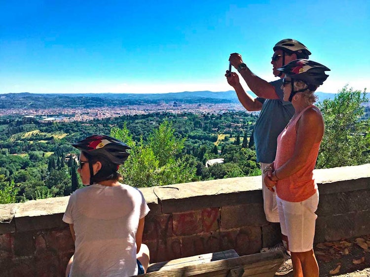 Family adventure tours from Florence, sliding downhill on a biking tour
