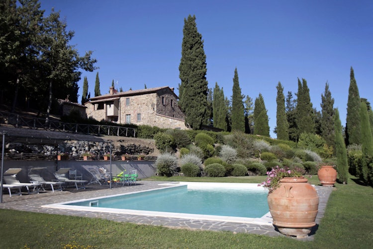 Spacious garden area with pool and lush green areas at Camporsevoli